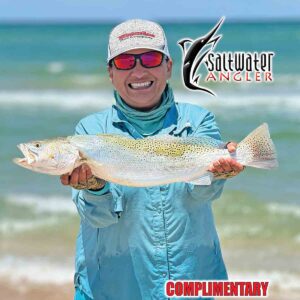 Silver Guerra with her personal best speckled trout that she caught in the surf on Padre Island with Saltwater Angler Magazine contributor, Jeff Wolda.